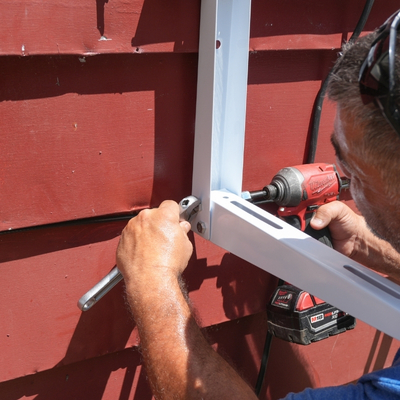 Securing weldbrackets to the outside wall of a home for a ductless mini split condenser installation