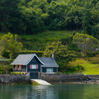 lake house mini split a small, black lake house with a boat port to the water