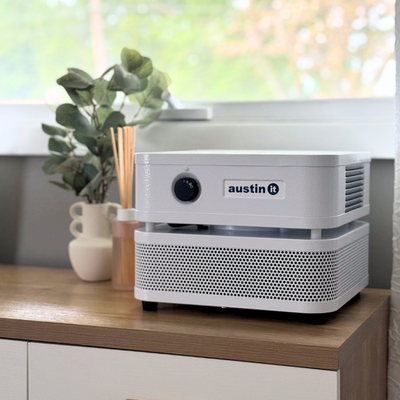 Austin Air it Air Purifier with VOC Carbon Wrap Austin Air it Air Purifier with VOC Carbon Wrap on a wooden side table