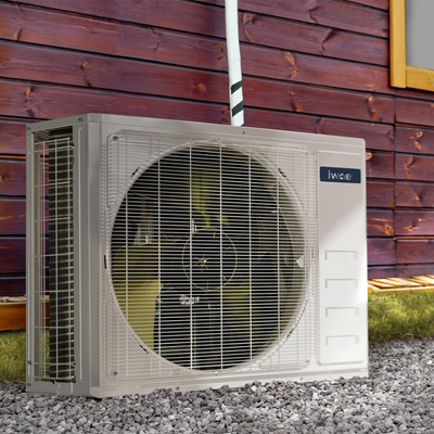IWAE TruInverter Ductless Mini Split Heat Pump Outdoor Condenser A IWAE TruInverter Ductless Mini Split Heat Pump Outdoor Condenser installed outside of a red panel wood house