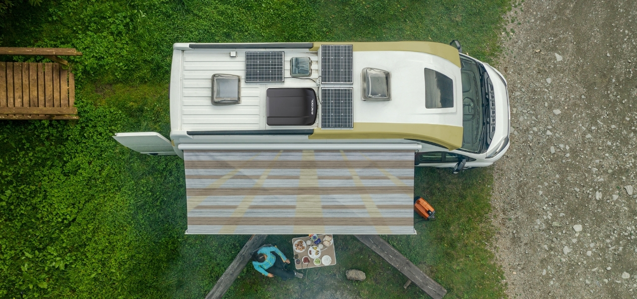Aerial view of MrCool TravelCool RV Inverter System: MrCool RV Outdoor Condenser rooftop unit on a camper van